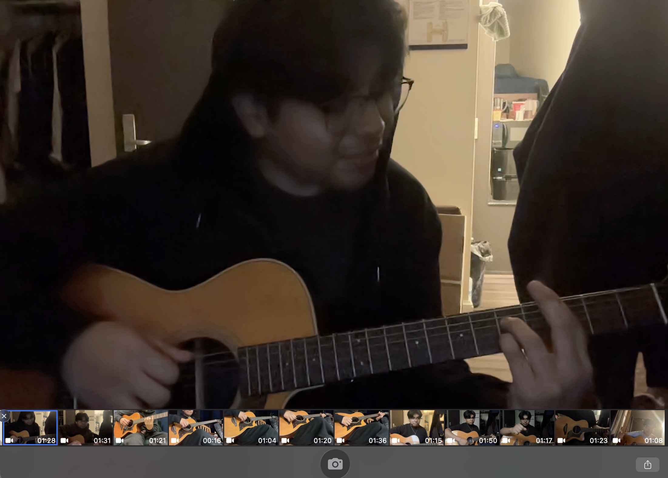 Practicing acoustic guitar in Photo Booth, with a strip of practice recordings along the bottom