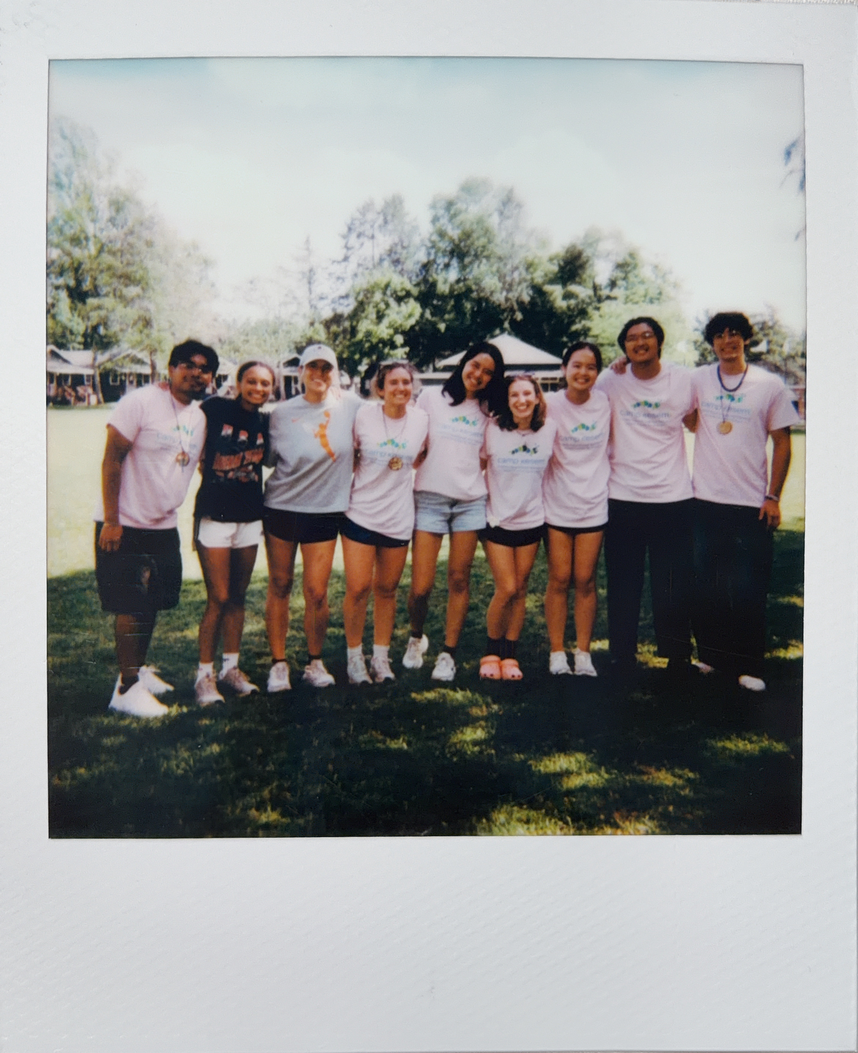 An instant photo of a group together at camp