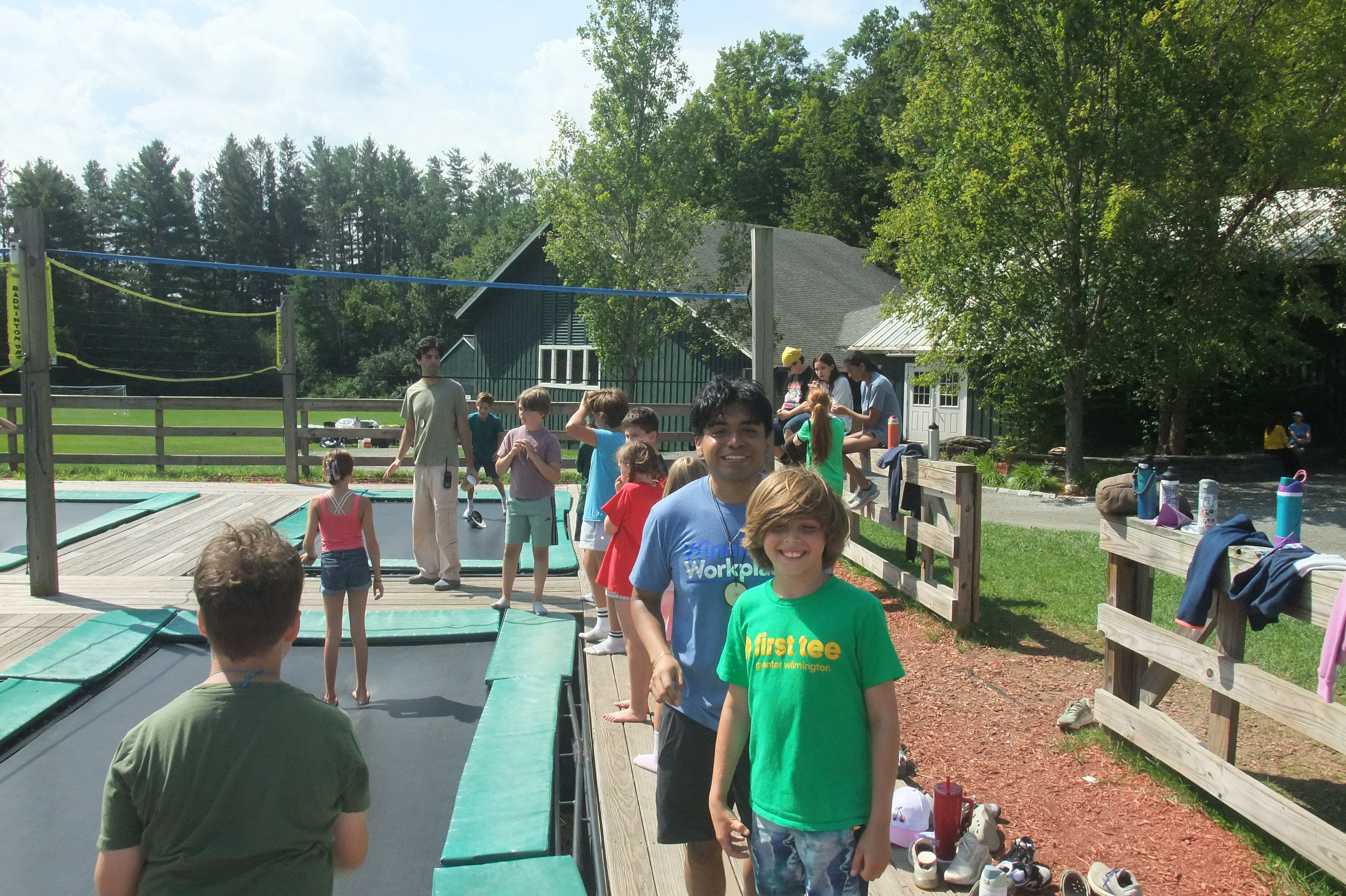 Camp participants beside an outdoor trampoline area