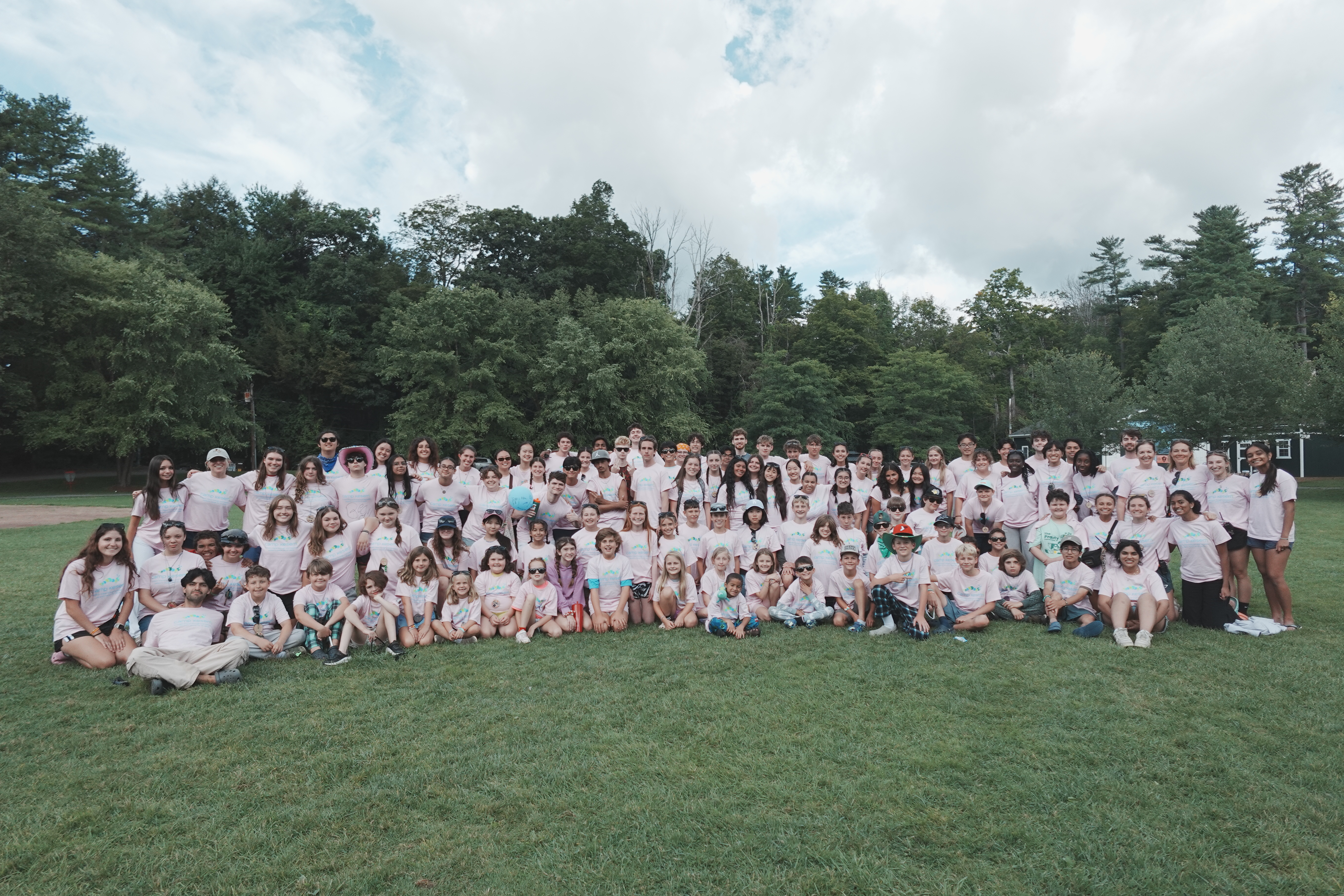 A large camp group posing together on the lawn
