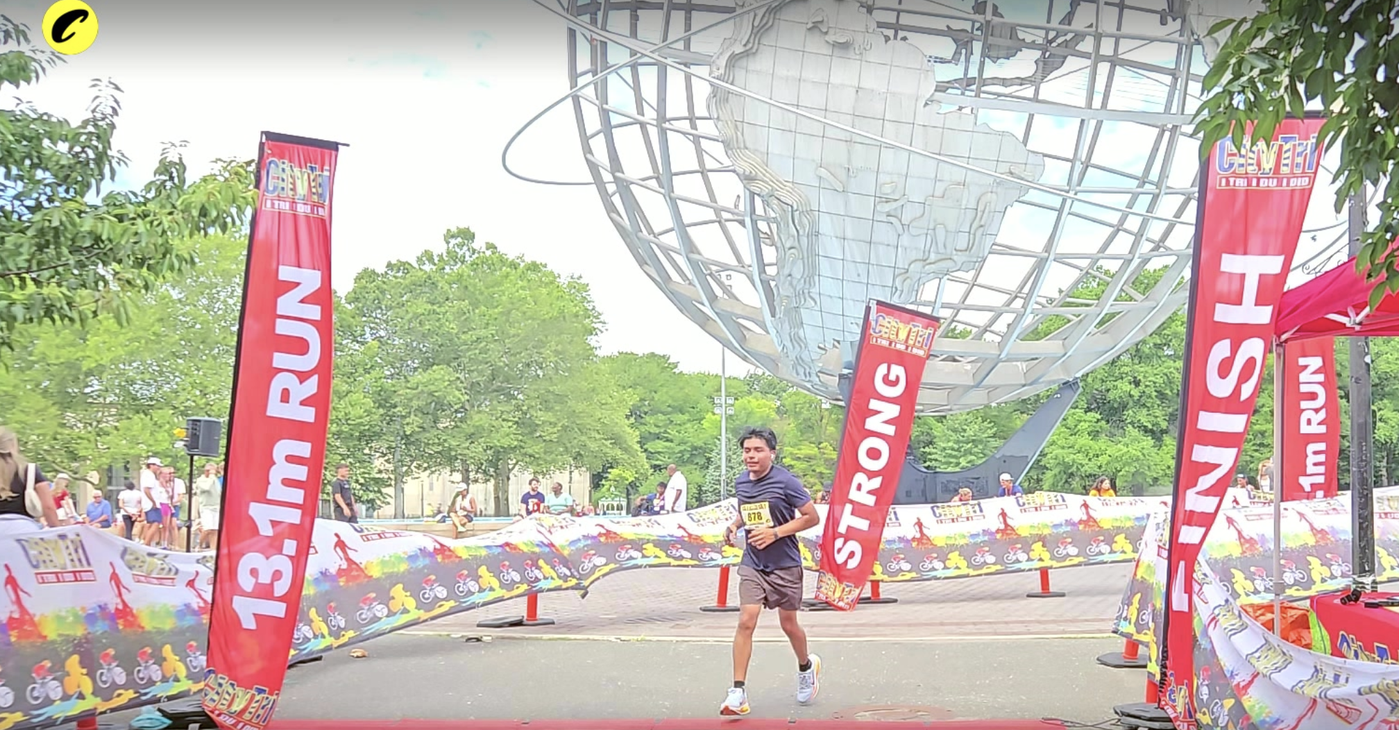 Crossing the Queens Half finish line beneath the Unisphere